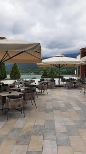 a patio with tables and umbrellas on a building at Vacation house in Pravets golf resort At Pravets Lake in Pravets +45 photos