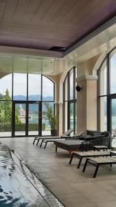 a room with a pool and chairs and windows at Vacation house in Pravets golf resort At Pravets Lake in Pravets