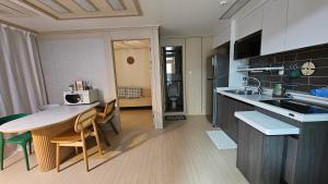 eine Küche mit einer Theke und einem Tisch mit Stühlen in der Unterkunft My comfortable second house in Seoul