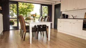 a kitchen with a white table and chairs at De Boalder in Hardenberg