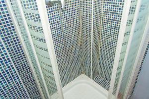a shower with two tall buildings in a room at Loft Parc Guell in Barcelona