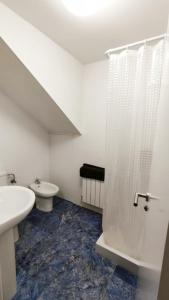 a white bathroom with a sink and a shower at Morgon House in Molinaseca +15 photos