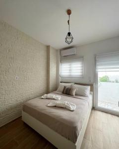 a bedroom with a large bed with a large window at "Calm Joy & J" - Family in Ermoupoli