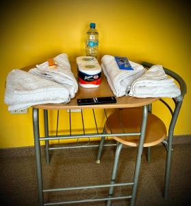 a table with towels and a bottle of water on it at UMERSA SUITE HOTEL in Espinar