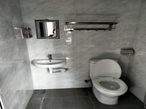a bathroom with a toilet and a sink at OYO 90953 Song 99 Hotel in Kluang