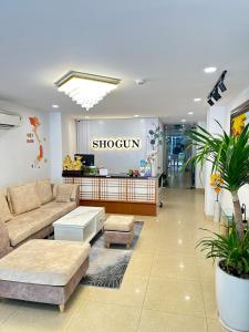 a showroom with a couch and tables in a store at Shogun Hotel in Ho Chi Minh City