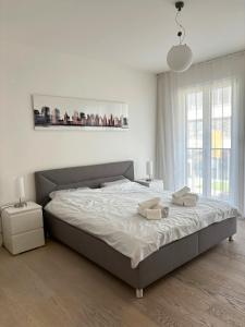 a bedroom with a large bed with two towels on it at Luxury 2-Bedroom Flat close to FAIR & OLD TOWN in Düsseldorf