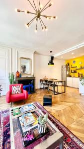 a living room with a red couch and a table at Bright, spacious apartment in the heart of Lyon in Lyon