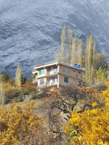a building on the side of a mountain at Hunza Lounge in Hunza