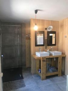 a bathroom with two sinks and a shower at Maison de charme avec piscine in Vignoux-sous-les-Aix