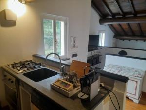 a kitchen with a sink and a stove top oven at Mansarda Portofino in Portofino