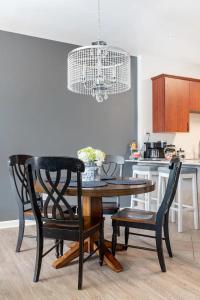 a kitchen with a table and chairs and a chandelier at Blue Oasis in Dearborn