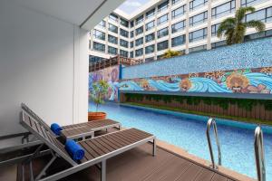 a swimming pool with a mural on the side of a building at Four Points by Sheraton Boracay in Boracay