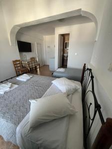a bedroom with two beds and a living room at Stella Nomikou Apartments in Firostefani
