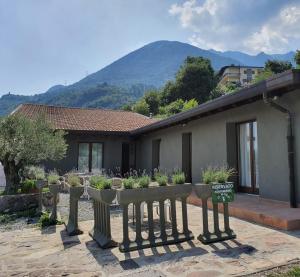 a fence with potted plants in front of a house at Agriturismo Il Moro in Angolo Terme