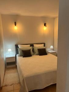 a bedroom with a large bed with two night stands at Suite et Spa Les Abatilles in Arcachon