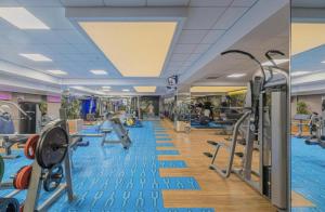 a gym with exercise equipment and a swimming pool at Best Residence Rin Grand Hotel in Bucharest