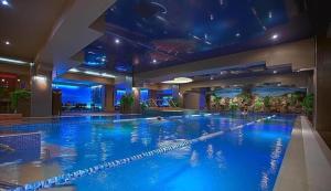 a large swimming pool in a hotel at Best Residence Rin Grand Hotel in Bucharest