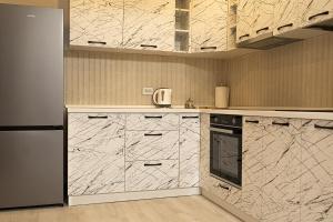 a kitchen with marble counter tops and a refrigerator at Best Residence Rin Grand Hotel in Bucharest