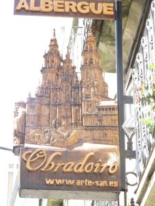 a sign for a barrio in front of a building at Obradoiro in Sarria