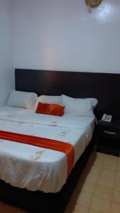 a bedroom with a large bed with a black headboard at Blue Moon Hotel Victoria Island in Lagos