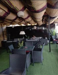 a restaurant with tables and chairs under a roof at Blue Moon Hotel Victoria Island in Lagos
