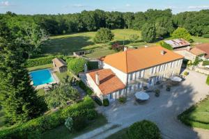 an aerial view of a house with a swimming pool at Domaine de Laguneaussan in Lesparre-Médoc +10 photos