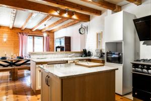 a kitchen with a counter top and a stove top oven at Gite des Rousses d'Amont - 15 personnes in Les Rousses