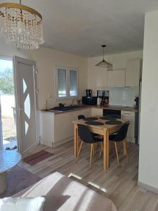 a kitchen and dining room with a table and chairs at MAISON saint emilion in Saint-Émilion