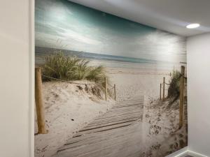 a painting of a boardwalk to the beach at Christinas Fewo DÜNE 43 in Salzgitter Thiede in Salzgitter