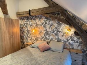 a bed with two pillows in a bedroom at Logement cocon in Chaudenay