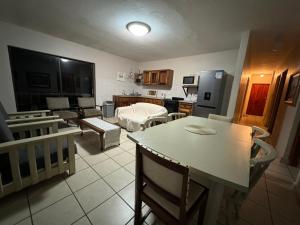 a kitchen and living room with a table and a couch at Chandos Apartment Vleesbaai in Vleesbaai