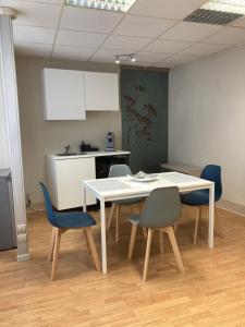 a table and chairs in a room with a kitchen at Gîte d'Avalon Appartement 5 in Dinant