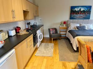 a small kitchen with a bed in a room at Neema in Barnstaple