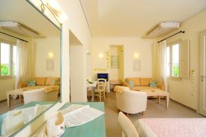 a living room with a table and a mirror at Petrokalli Houses in Kálamos Kythira