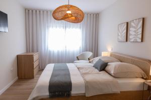 a bedroom with a large bed with a large window at Blue House- am Strand von Vila do Conde, Porto in Vila do Conde +38 photos