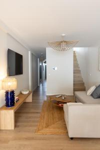 a living room with a couch and a staircase at Blue House- am Strand von Vila do Conde, Porto in Vila do Conde