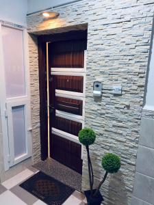 a door to a building with two plants in front of it at Appartement Luxe F4 Bordj El kiffan in Fort de lʼEau