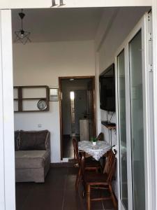 a living room with a table and a couch at Xaxa Apartments in Ulcinj