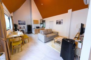 a living room with a couch and a table at Hi Hills Khao Yai in Ban Bung Toei