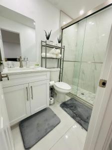 a white bathroom with a shower and a toilet at Green planet in Naples