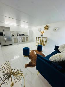 a living room with a blue couch and a kitchen at Green planet in Naples