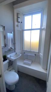 a bathroom with a sink and a toilet and a window at Ellwyn House in Edinburgh