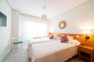 Postel nebo postele na pokoji v ubytování Apartamentos GO - Génova Parquesol - Parking Gratuito