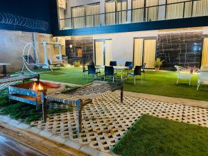 a backyard with a fire pit and a table and chairs at Farmhouse with pol near golf course road,Gurgaon in Gurgaon