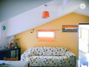 a living room with a couch and a window at Tramonto sul Mare in Agropoli