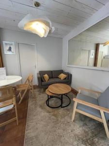 ein Wohnzimmer mit einem Sofa und einem Tisch in der Unterkunft Le cocon - Maison 2 chambres avec jardin - Tout à pied in Le Croisic