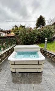 a hot tub sitting on top of a patio at Residence Oleandro in Domaso