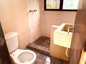 a small bathroom with a toilet and a sink at Container Manglar House in Nautla