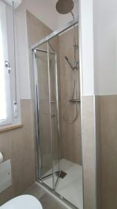 a shower with a glass door in a bathroom at Al Civico 2 in Pordenone